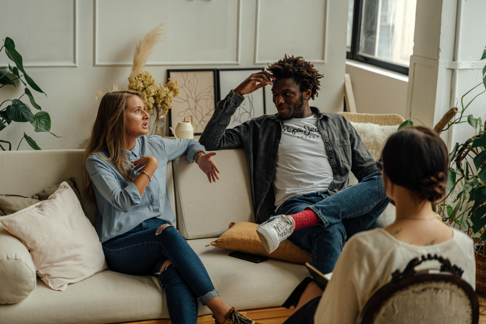 A couple talking together on a couch during a coaching session